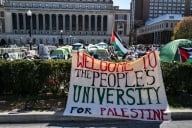 A sign that says welcome to the Peoples University for Palestine on a Columbia’s campus with tents